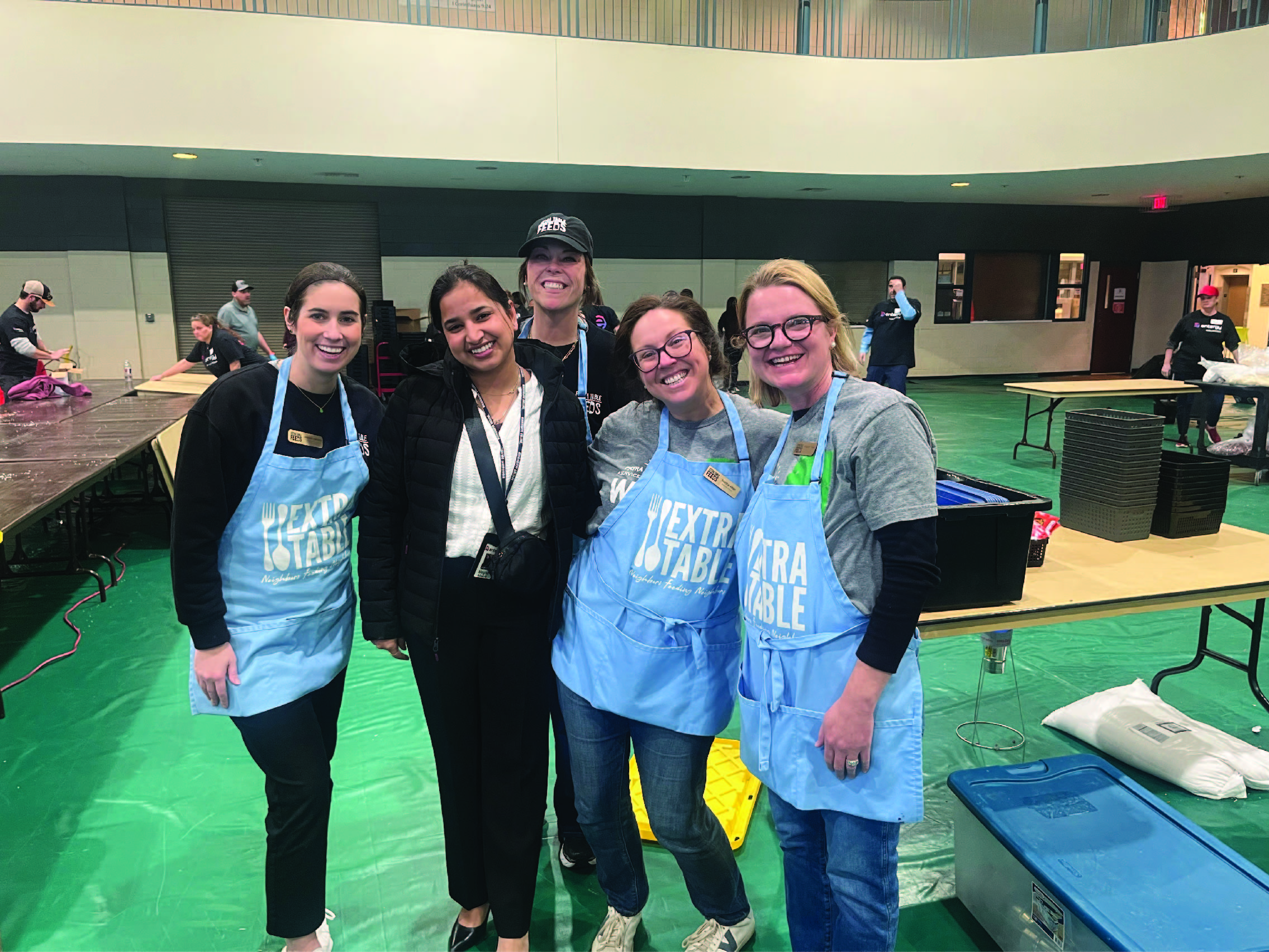 Entergy Mississippi team member Megha Makol (second from left) joins other volunteers and representatives from community partner Extra Table for a meal-packing event following her wedding held recently in Jackson.